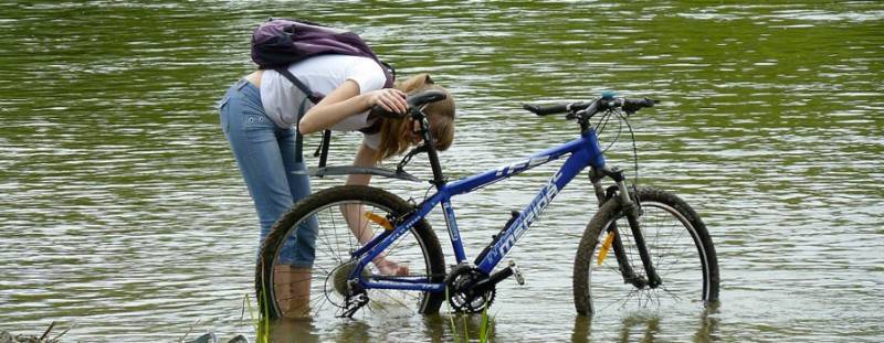 Кинешь в речку не. Велосипед у реки. Велосипед у водоема. Мойка велосипеда. Велосипед на воде.